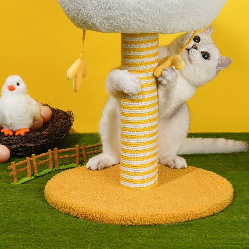 Cat playing on a yellow-striped scratching post that has chicken leg toy hanging below the cat condo