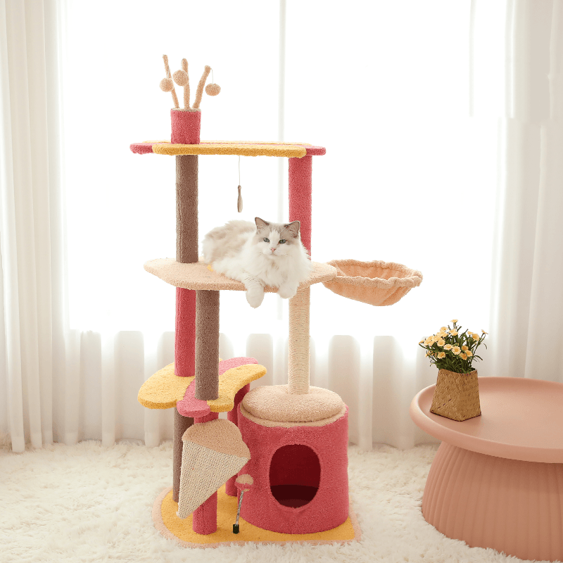 Pastel color pink cat tree with three levels with features of a cat condo and hammock