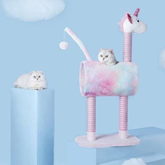 Cat in a rainbow-colored unicorn cat tree design. Its features include a hanging ball toy in its tail, a cat condo, and a scratching post.