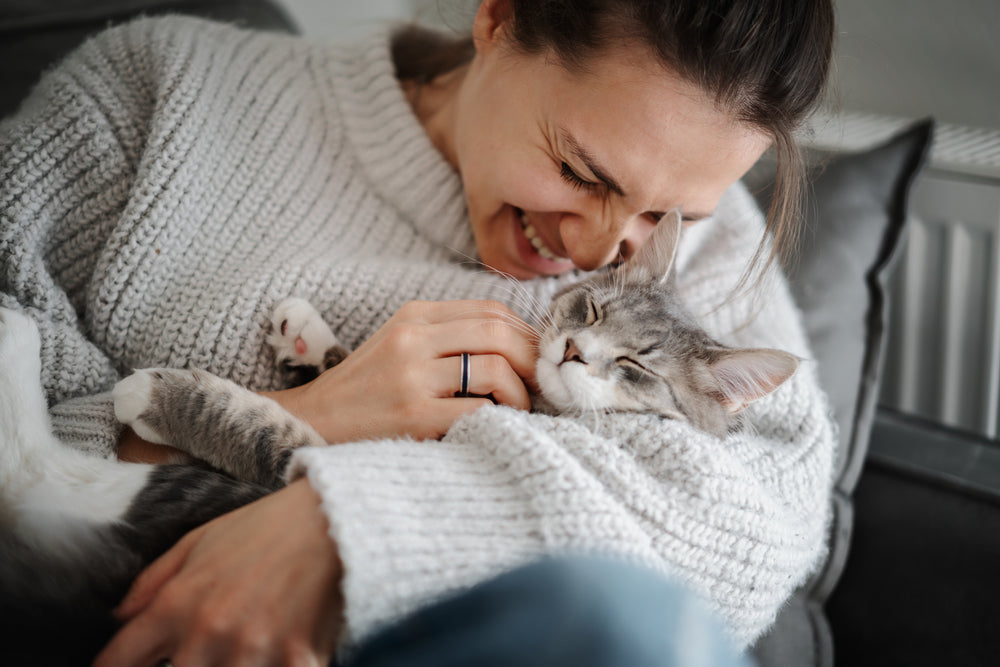 Woman smiling while holding cat