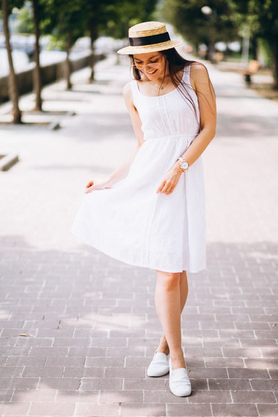 woman wear white dress & flat shoes