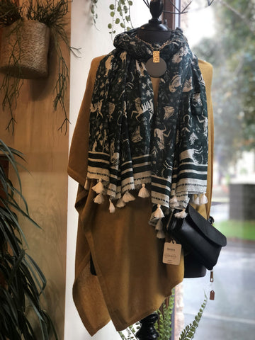 mustard poncho green and white pattern scarf and black bag