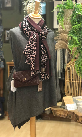 Dark grey poncho with plum and pink animal print scarf and plum bag