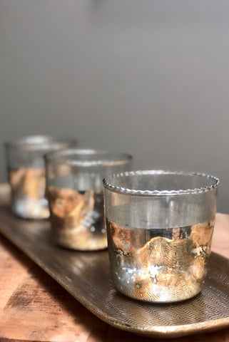 Abigail Ahern Glass and gold leaf tealight votives on a metal tray