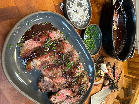 Steak in red wine pan sauce on gather platter