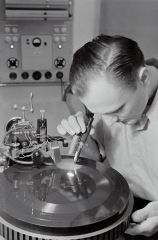 Man inspecting a vinyl record.