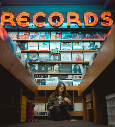Girl in a vinyl record store.