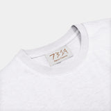 7319 blanc white t-shirt with logo, front shot, zoomed to logo alterantive