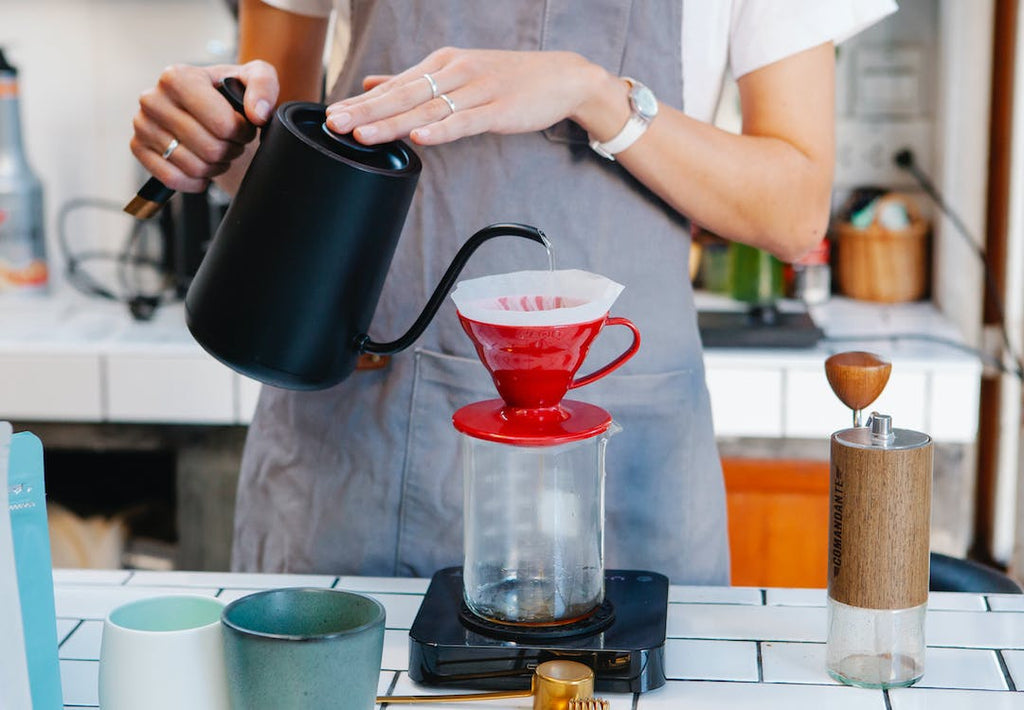 Image of a woman pouring coffee into a cup