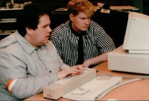 Mark working with a client using Braille display