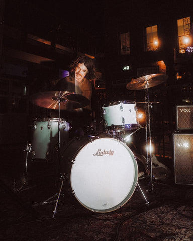 Jasper Smythe playing drums on the WB patio