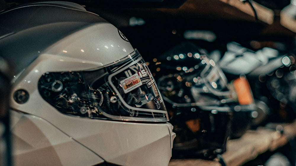 motorcycle helmets displayed on a shelf