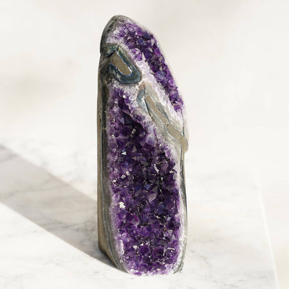 Amethyst in tower shaped.  Traditional polish allowing us to admire its bands of sparkling white quartz, bright green celadonite, and deep blue-greenish agate. All layers of minerals are in balance, representative of the richness of the Uruguayan land