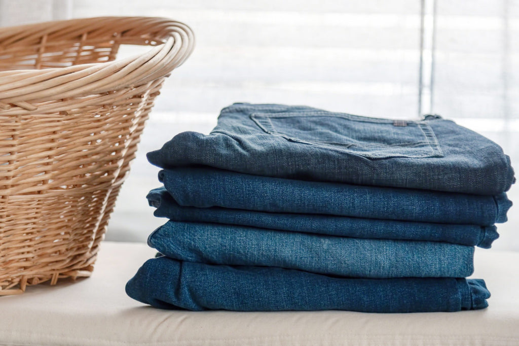 Folding Jeans and pants to save space in your dresser drawer.