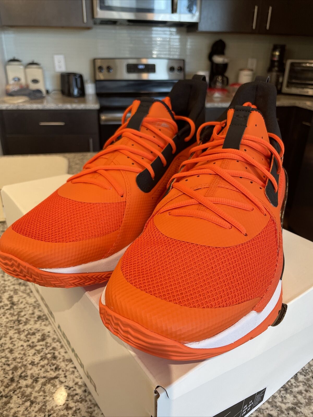 orange and black under armour basketball shoes