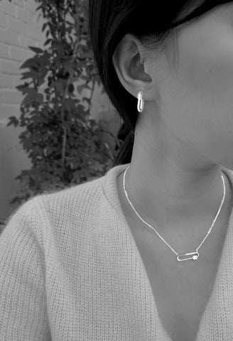 A model is wearing amy bel Korea Fashion earrings Dainty hoop and Clip Necklace in Silver Rhodium color.