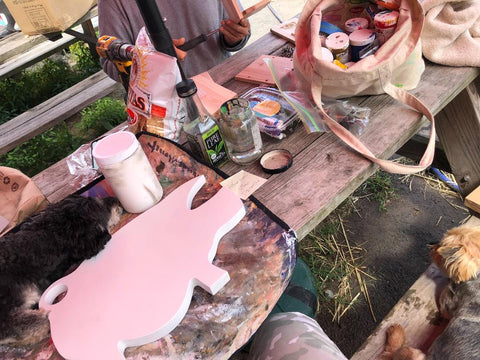 Painting wood pig sign at Arthur's Acres Animal Sanctuary farm with the dogs Allie for the Soul Allison Luci Art Allison Carney