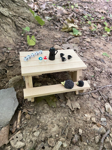 Tiny picnic table with tea set and hedgehogs