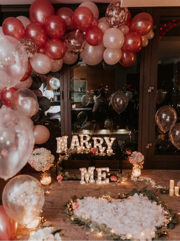 lavish proposal set up in an apartment with balloons and a marry me sign displayed