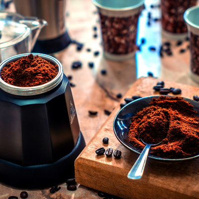 Coffee beans and grounded up coffee on a work surface 