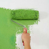 paint roller applying green paint to wall