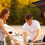 man and woman taking items out of shopping cart