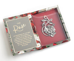 Silvertone rose ornament in a red gift box.  Lid is open which white topography of the rose on the inner lid