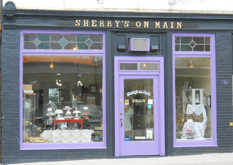 Image of a storefront painted purple and black.  The store is called Sherry’s on Main.