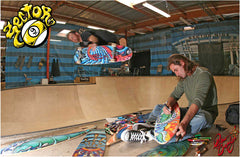 Drew Brophy painting sector9 skateboards on a halfpipe ramp with skater catching some air.