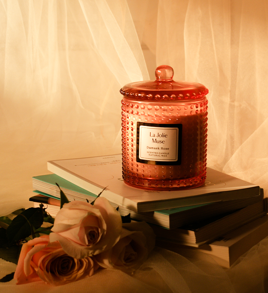 Glass Damask rose candle on books with roses