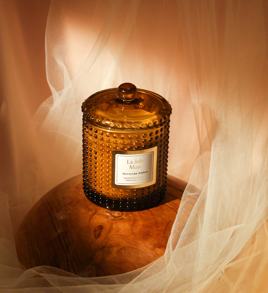 Brown glass Moroccan amber candle with tulle background