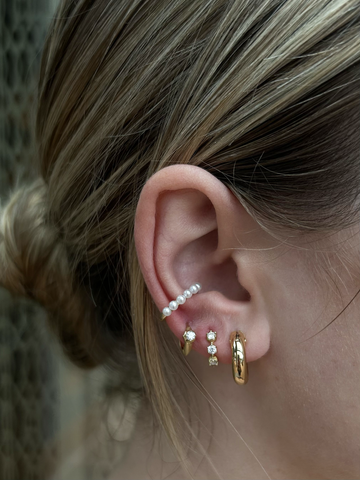 woman wearing yellow gold and diamond hoops