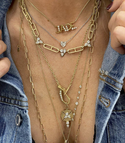 Woman wearing yellow gold chain necklaces and diamonds