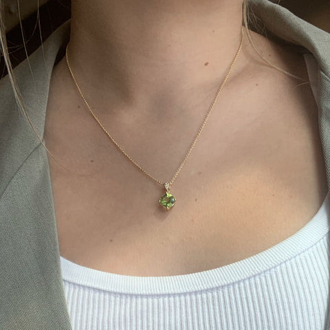 woman wearing a necklace with peridot gemstone