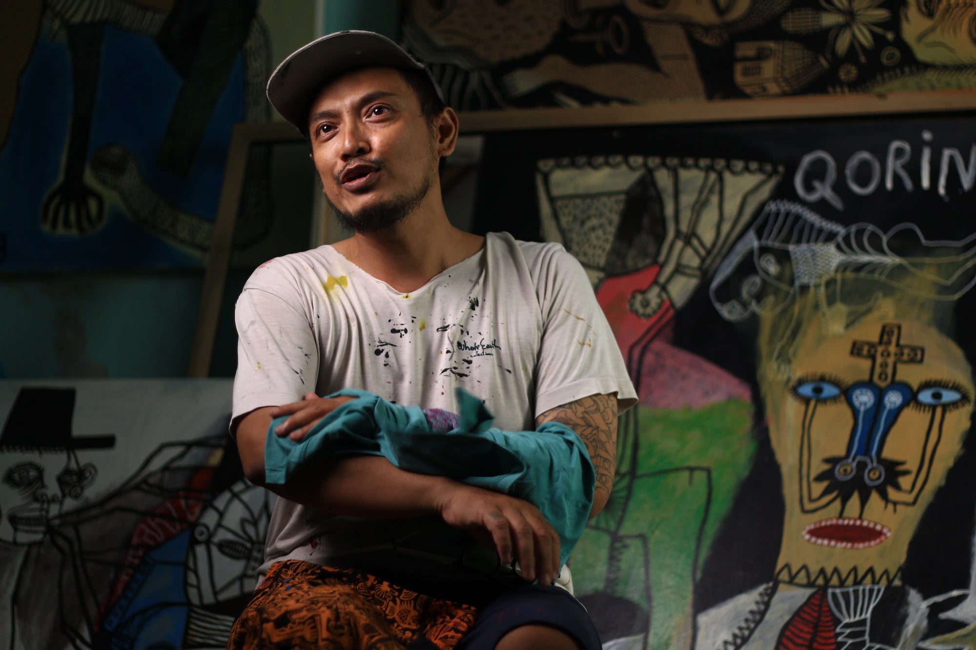 Artist Arwin Hidayat works on a batik print.