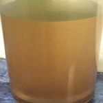 Jar of orange, rust-filled water