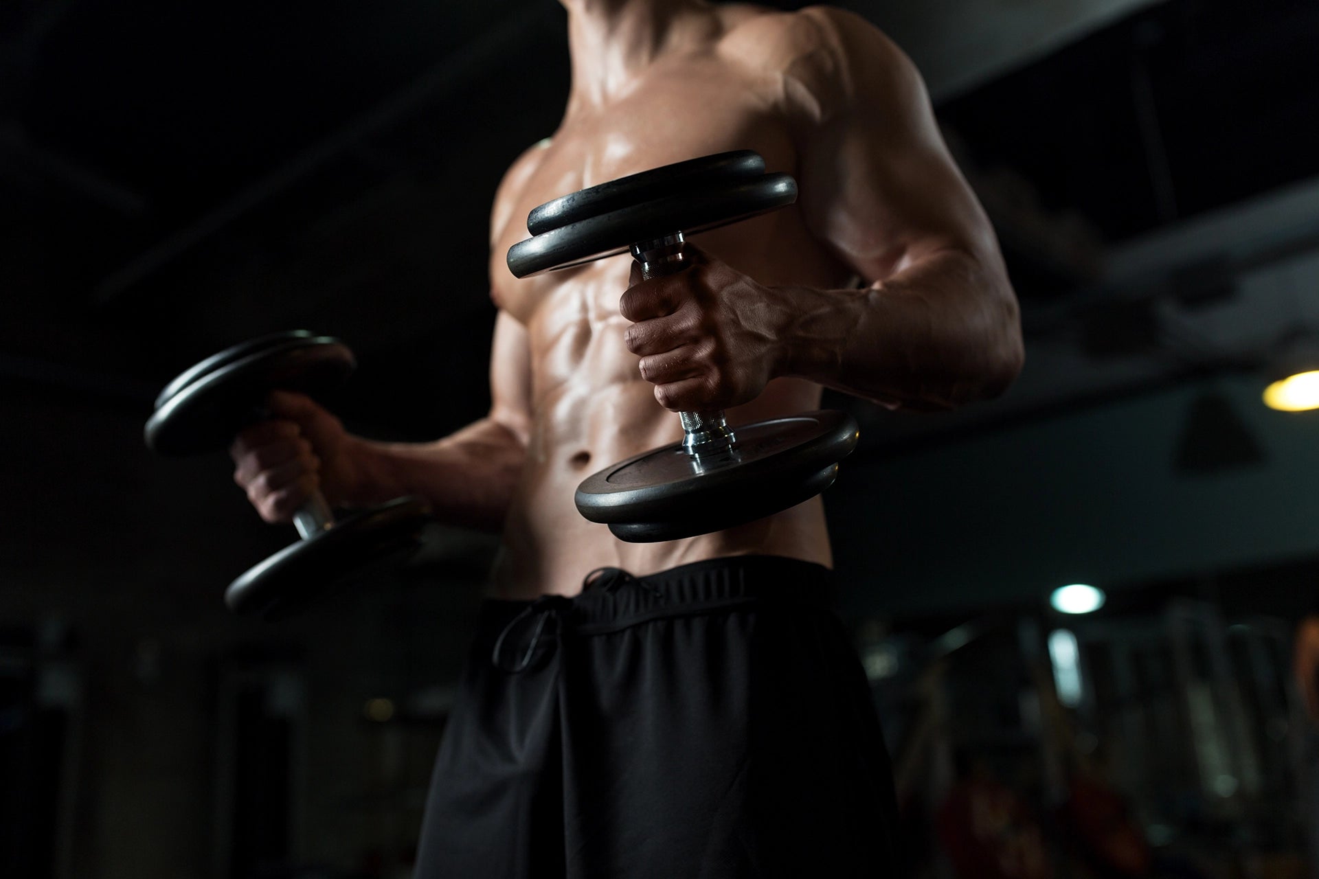 Close Up - Man With Dumbbells In Gym