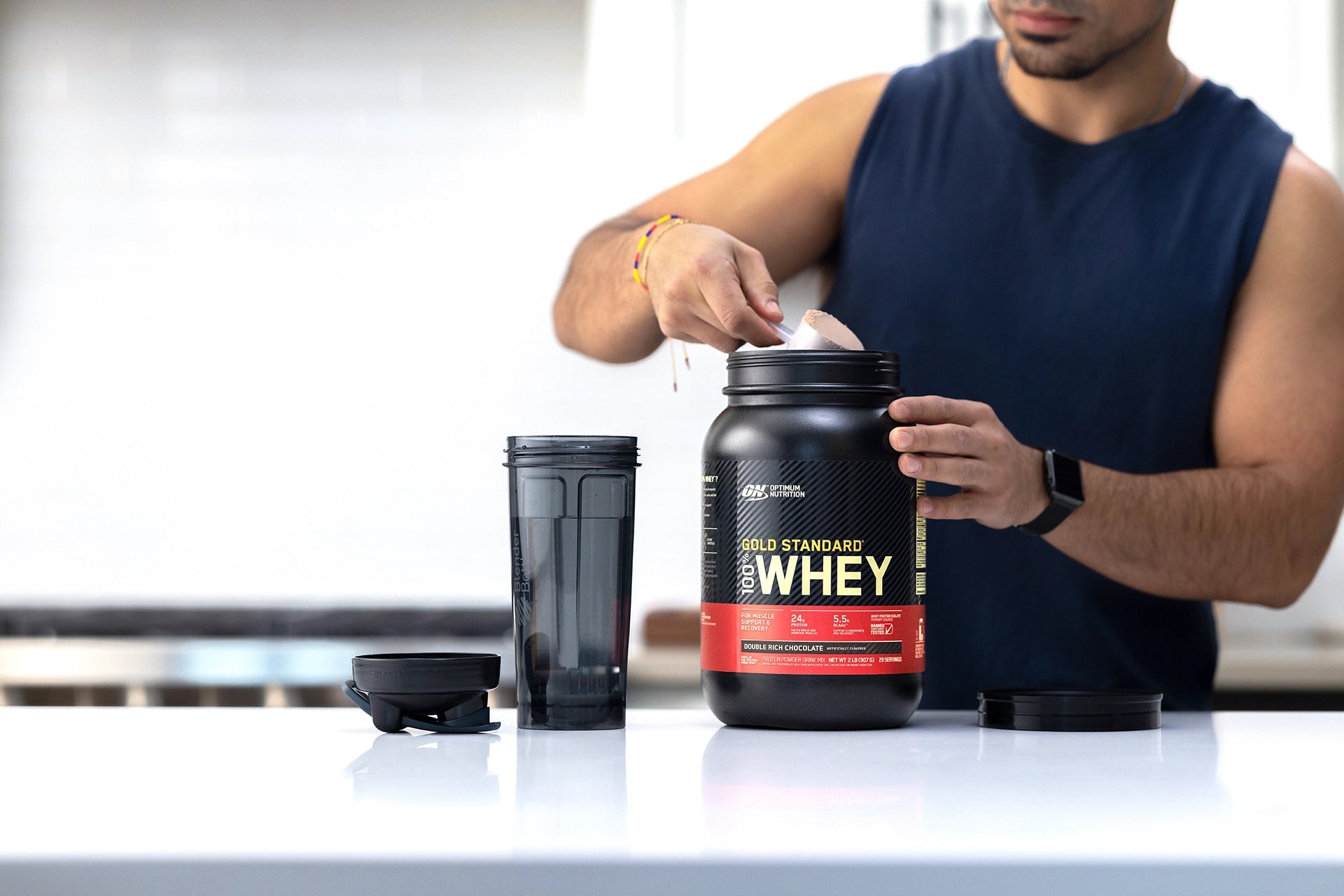 Guy making a protein Shake: Gold Standard Whey