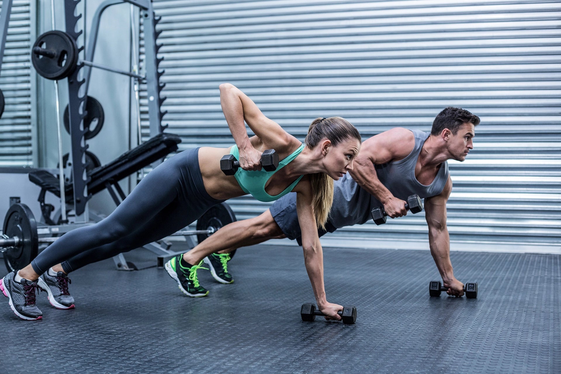 Man and woman working out, plank exercise