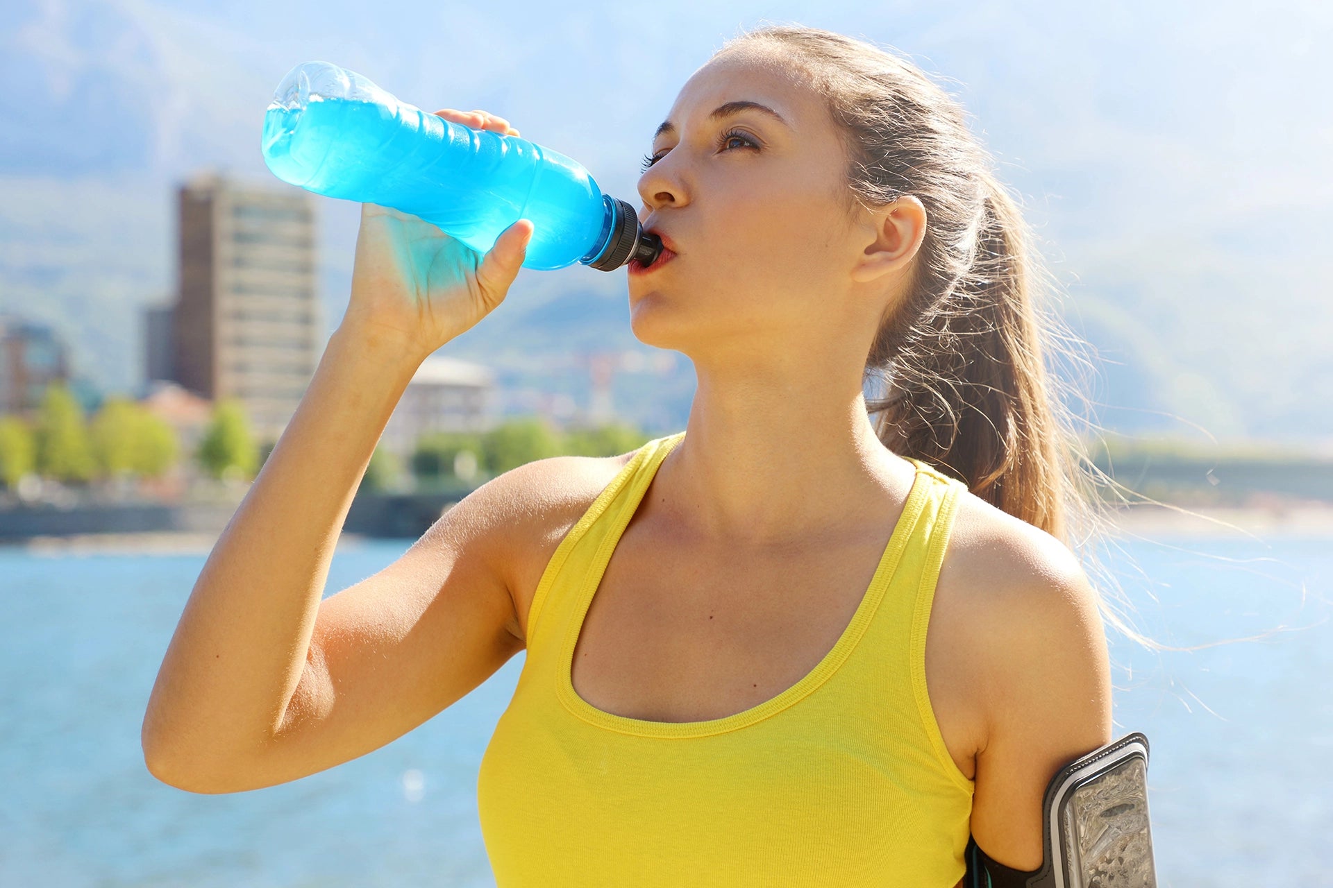 Woman Athlete Drinking Electrolytes Post Run