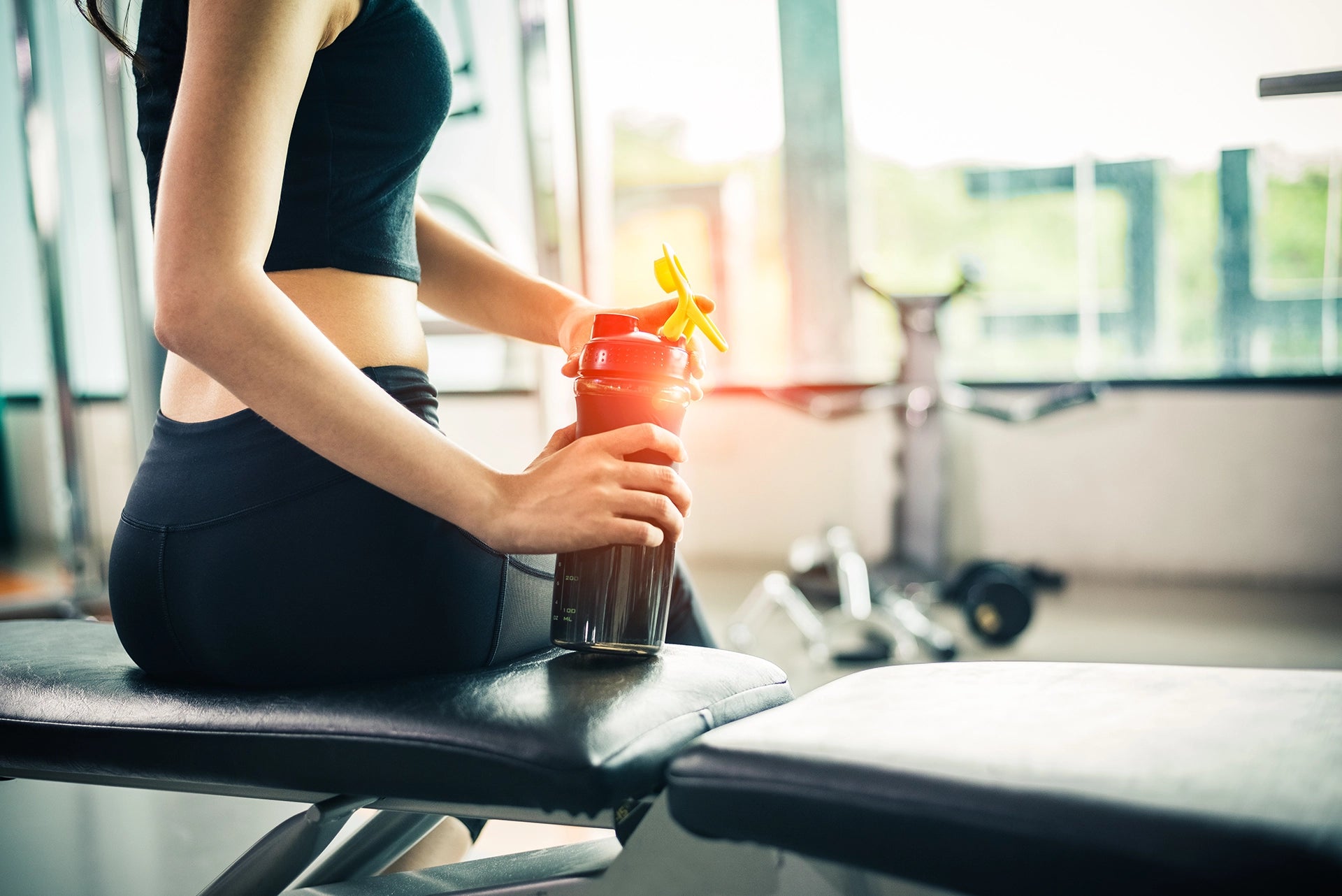 Woman Drinking Supplements in the Gym