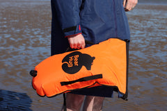 Bearhug | Swim Buoy Orange with waist strap in mans hand