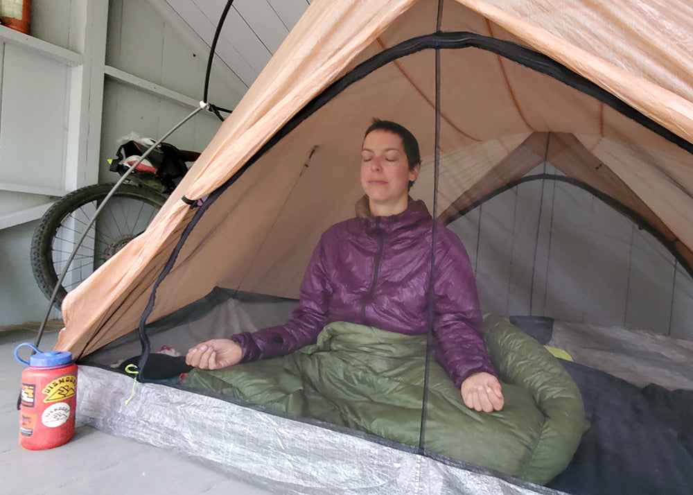 meditating in a tent as a way to wind down at the end of a day
