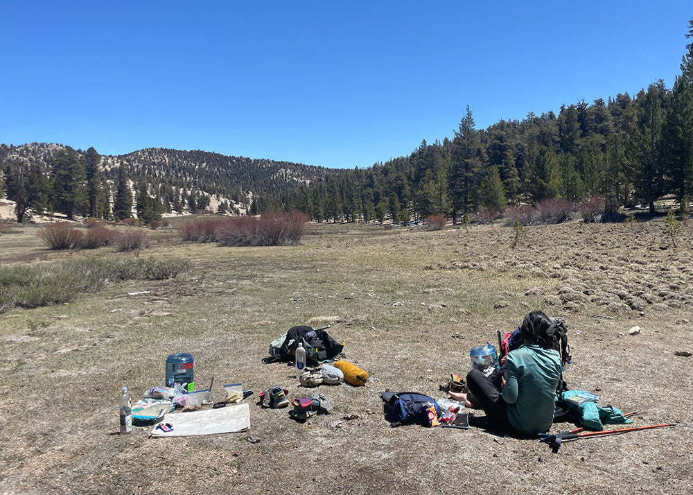 gear spread in a field with the tyvek footprint acting as a sit pad.