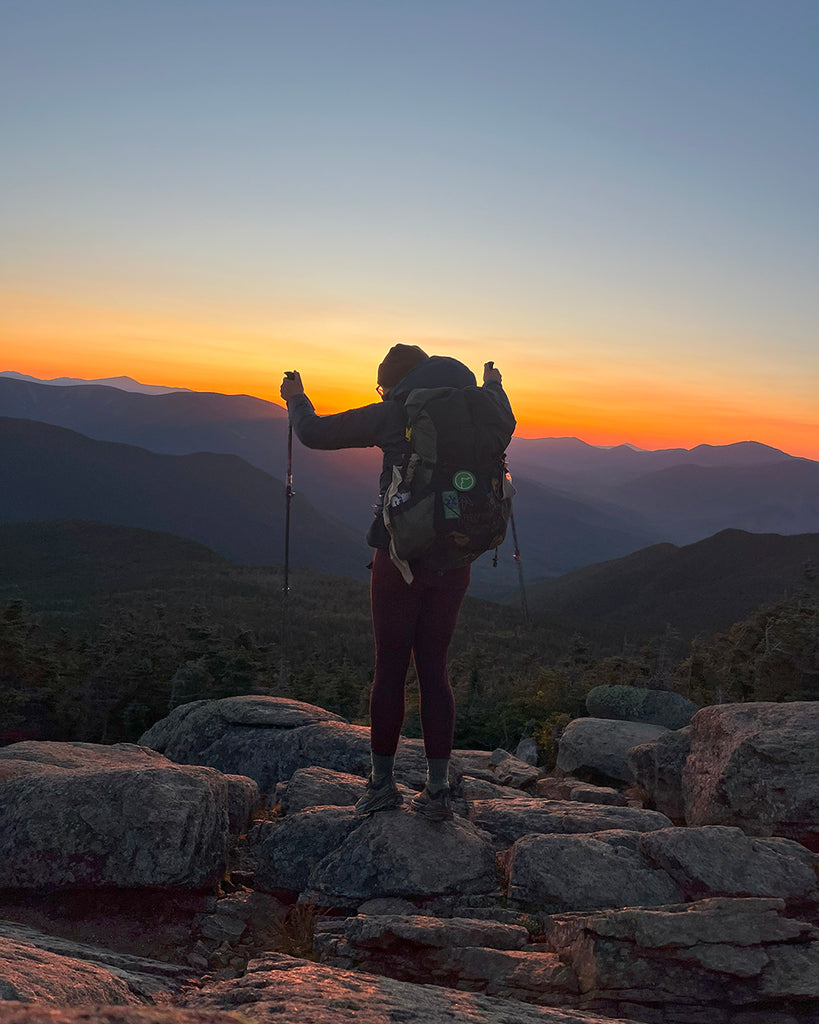 Abby Evans backpacking solo with sunset on Appalachian Trail