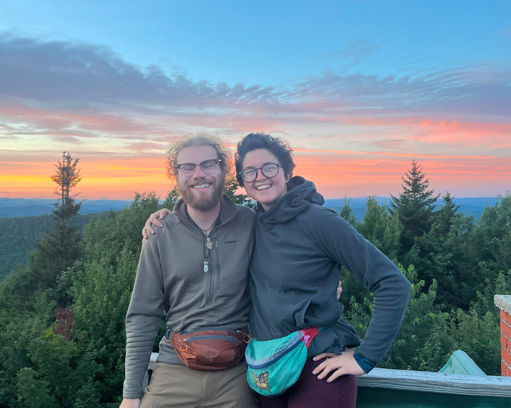 two happy hikers in front of a sunset on the Appalachian Trail
