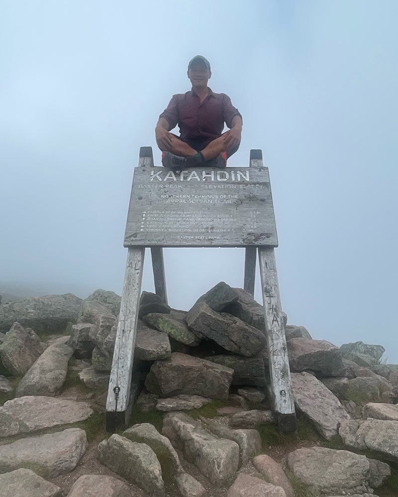 lil buddha sits on top of the Mt. Katahdin sign