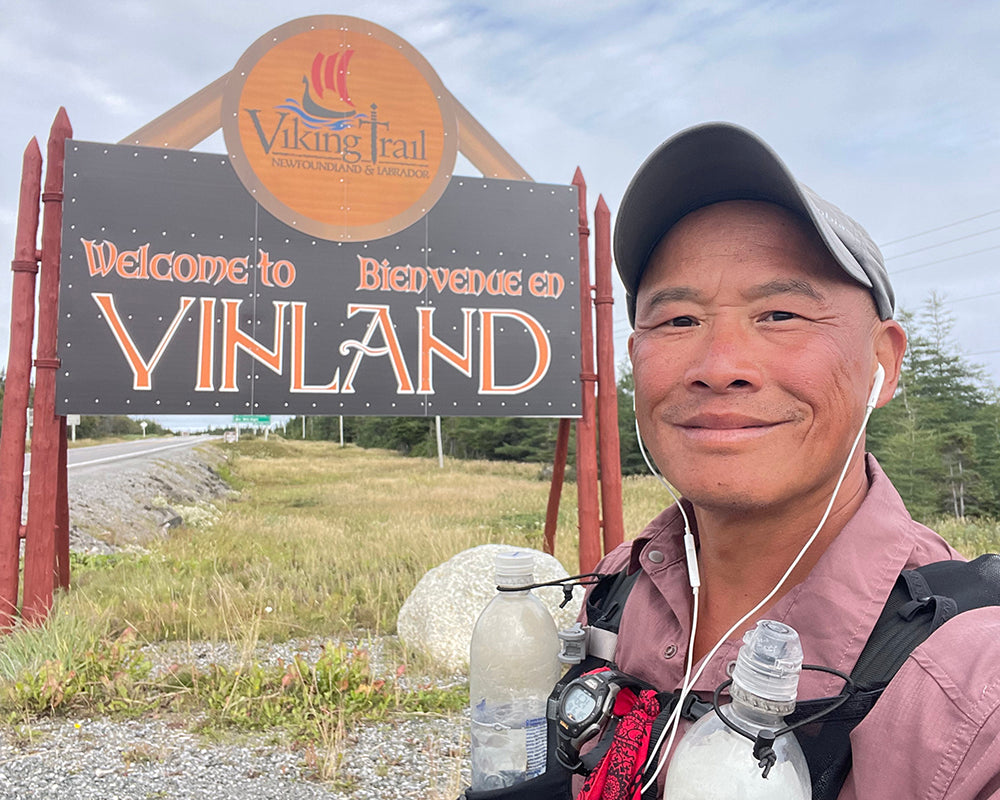 a selfie of lil' buddha in front of a sign for the Viking Trail