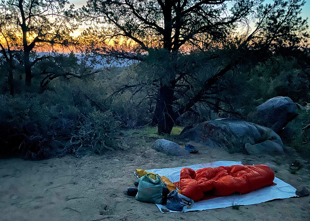 cowboy camping at dusk on a tyvek footprint