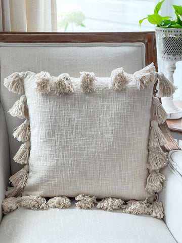 cream throw pillows with tassels